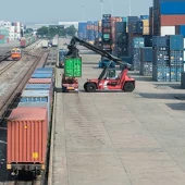 Loading containers form a road to a cargo rail