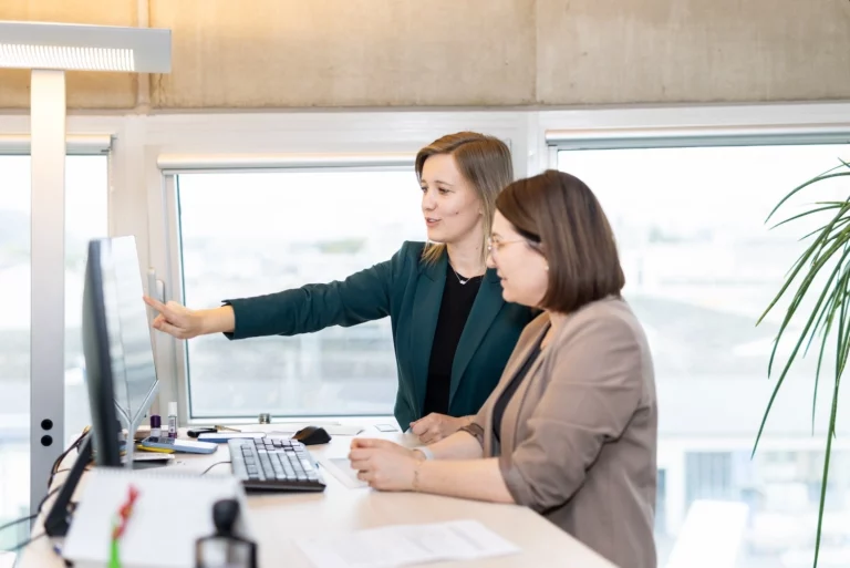 Two women working on end-to-end logistics management