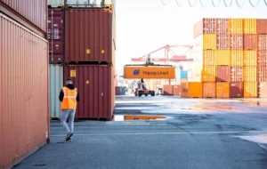 Logistics service provider eurotrans employee walking through a shipping container yard